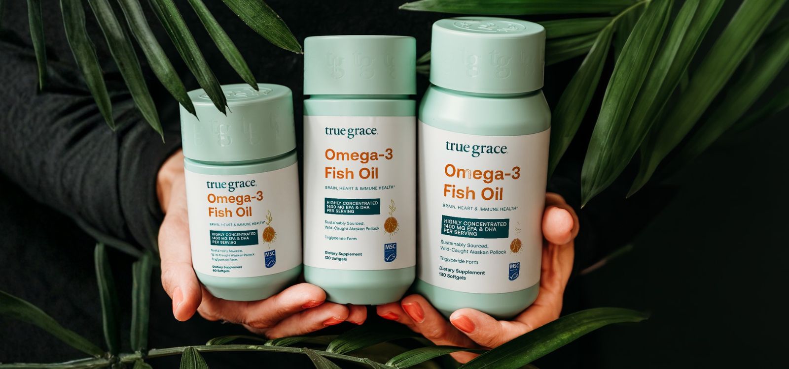 Omega-3 Fish Oil by True Grace held in palm leaves with new MSC Certified label