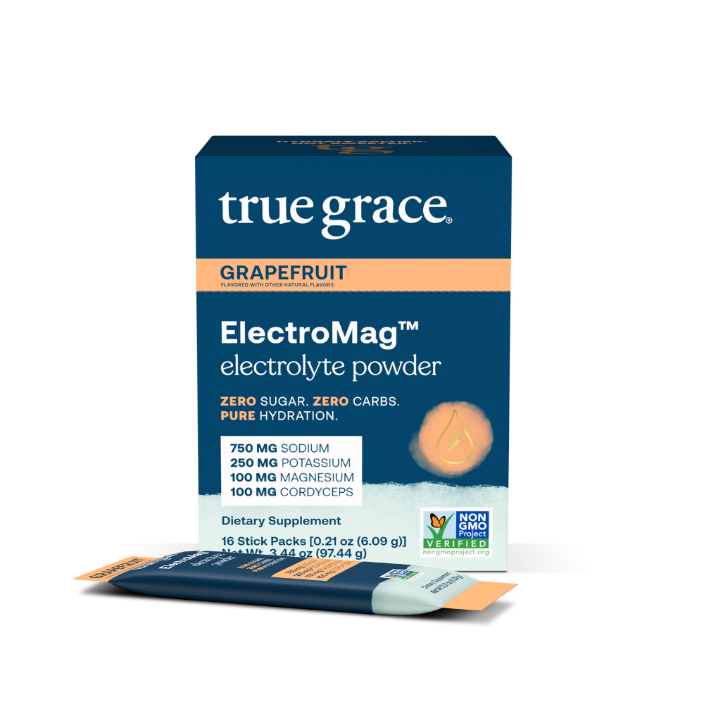 A box of True Grace ElectroMag electrolyte powder in grapefruit flavor. The packaging is blue with an image of a water droplet, and text highlighting zero sugar, zero carbs, and the inclusion of cordyceps mushroom.