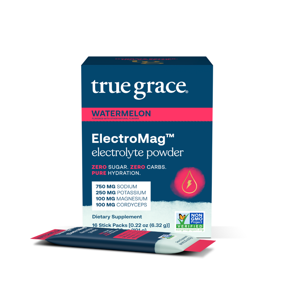 A box of True Grace ElectroMag electrolyte powder in watermelon flavor. The packaging is blue with an image of a water droplet, and text highlighting zero sugar, zero carbs, and the inclusion of cordyceps mushroom.