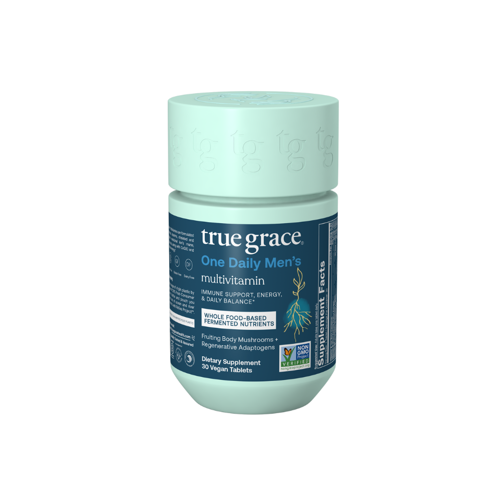A bottle of True Grace One Daily Men's Multivitamin with labels detailing the immune, energy, and daily balance benefits on a white background.