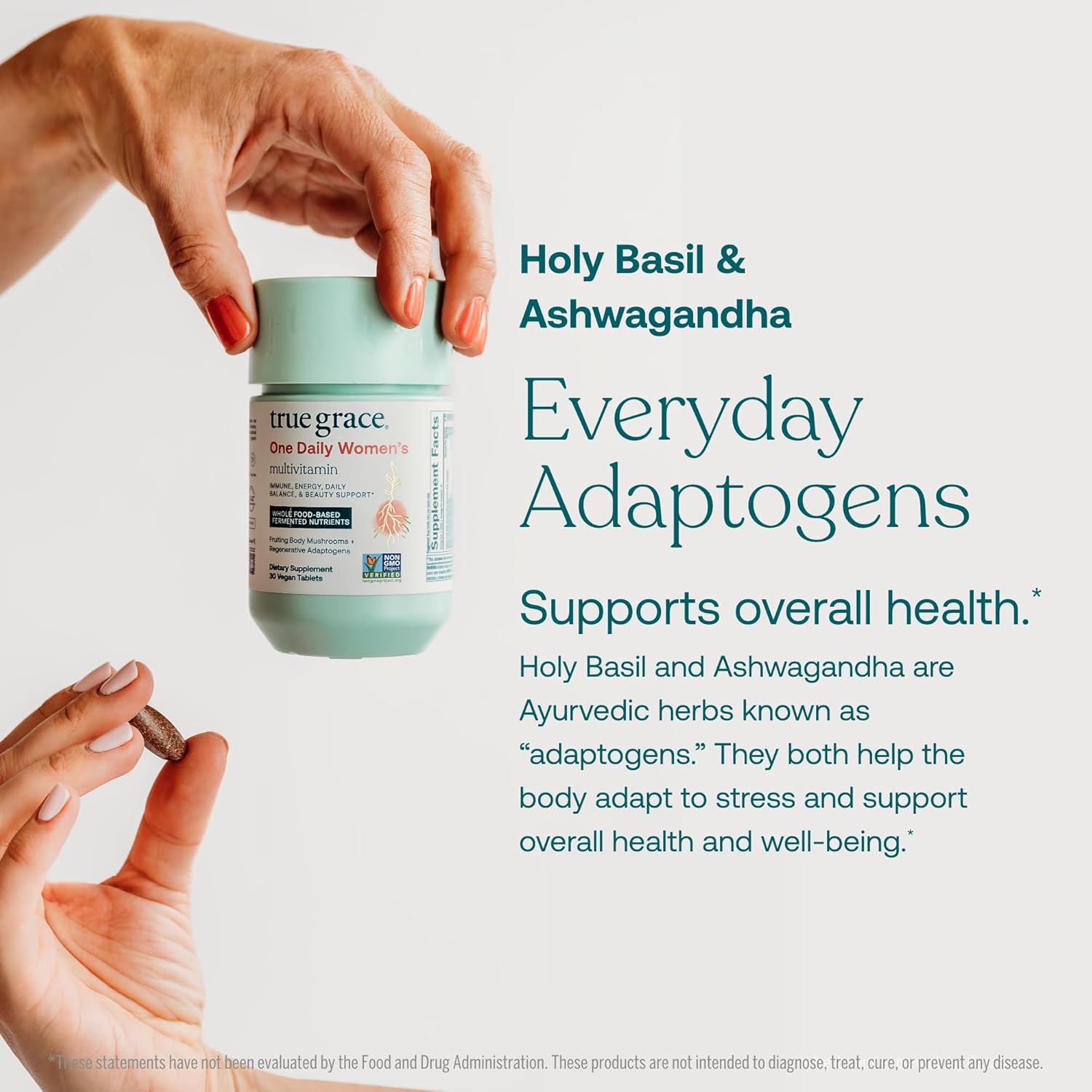 Hand holding a container of True Grace One Daily Women's Multivitamin and ingredients 'Everyday Adaptogens' with text about Holy Basil and Ashwagandha to support overall health.