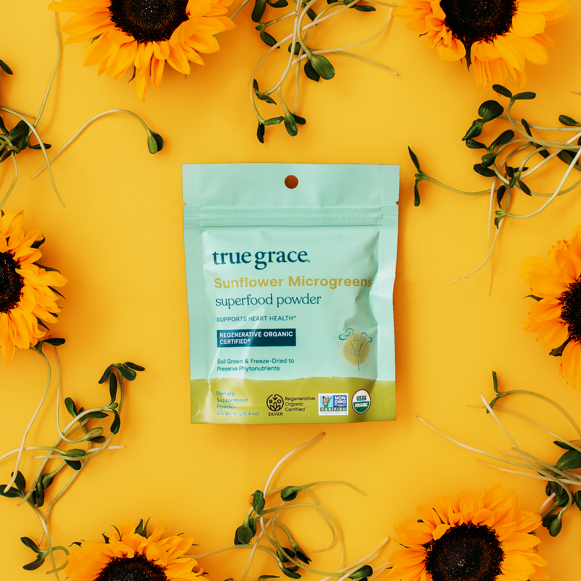 True Grace Sunflower Microgreens superfood powder product package on yellow background with sunflowers.