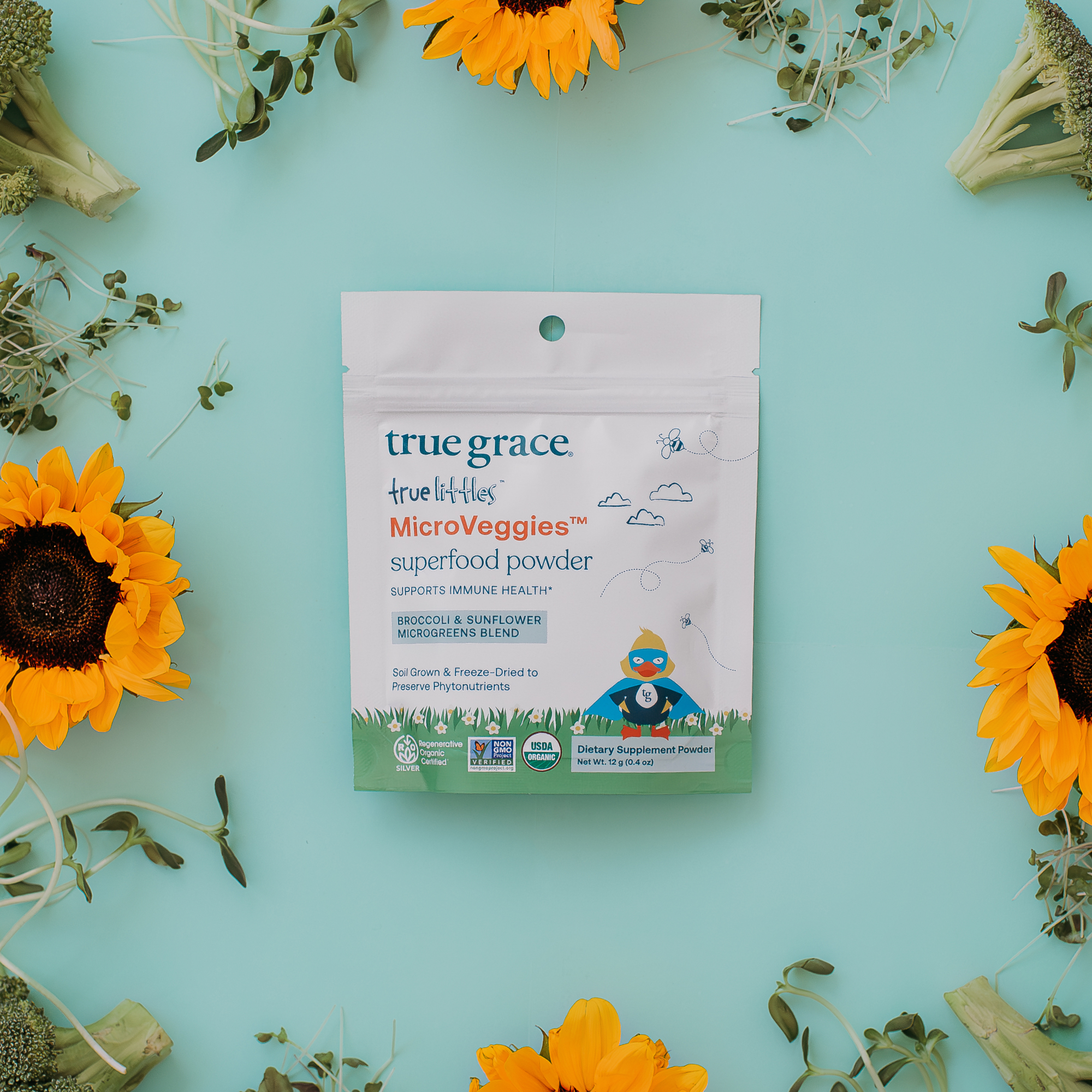 True Grace True Littles Microveggies superfood powder on blue background. Our microgreens may be tiny, but the way they’re grown makes a big difference for the health of people and planet.