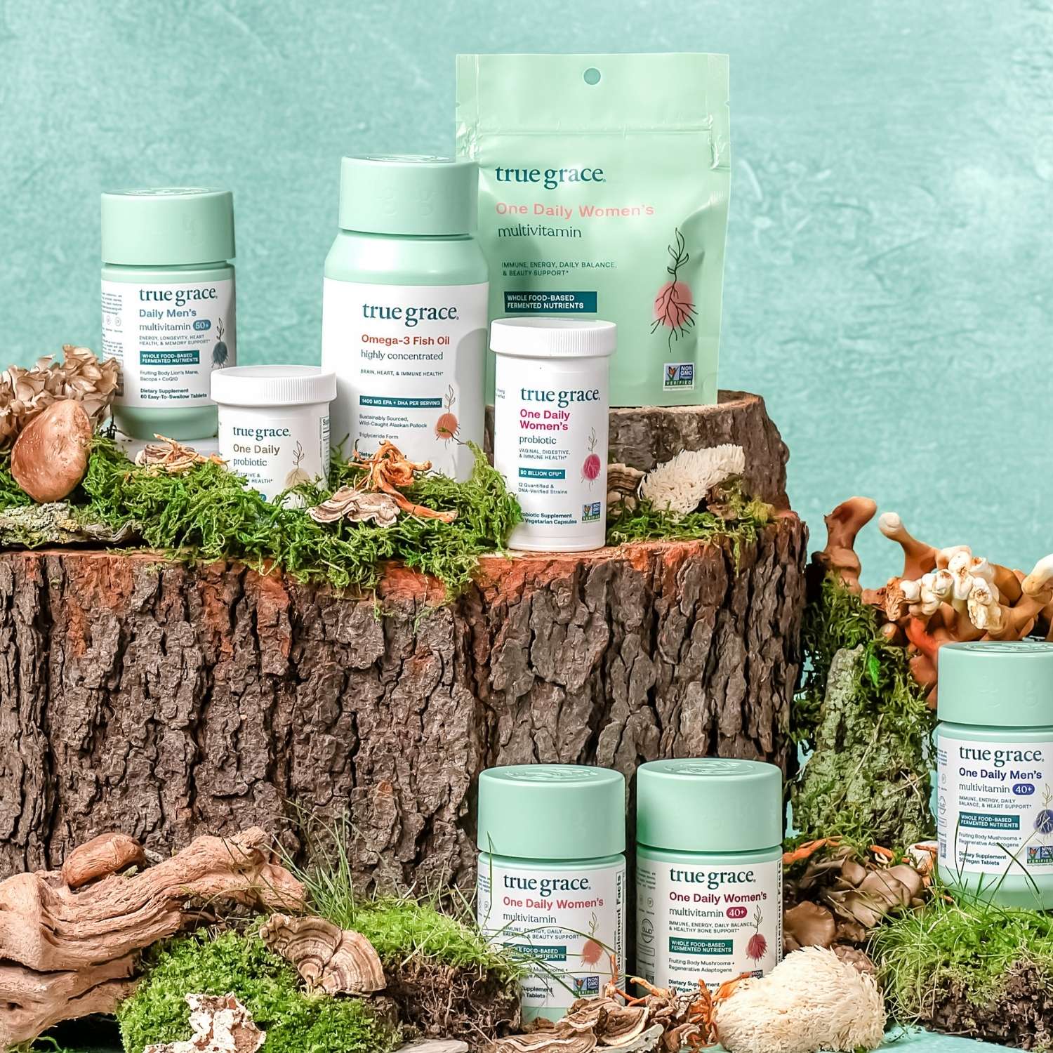 True Grace products displayed on a natural wooden and moss background