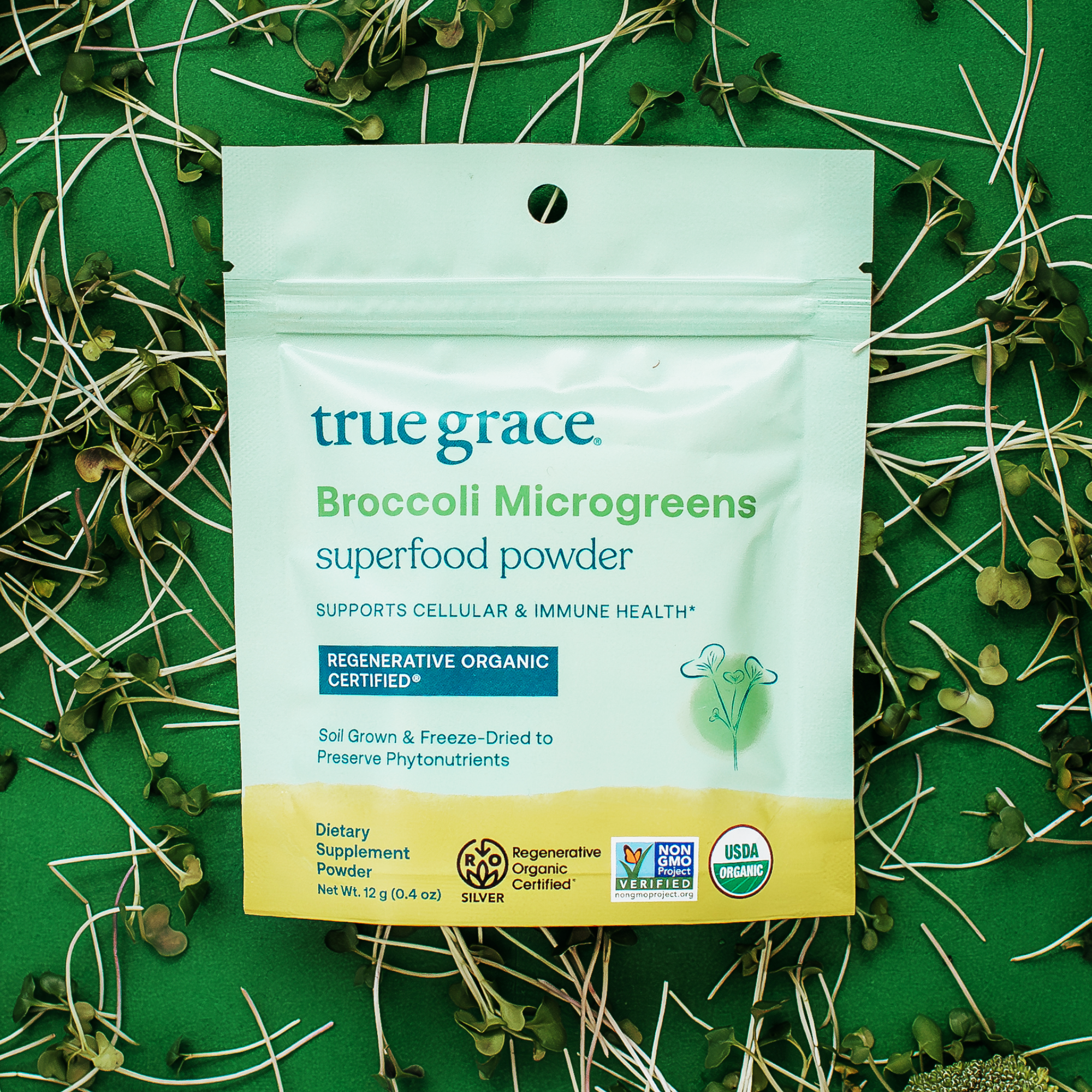 True Grace Broccoli Microgreens superfood powder product package on green background. Broccoli Microgreens have been shown in studies to gently support the detoxification process — aka the natural way your body eliminates toxins every day. Broccoli microgreens also support cellular and immune health.*
