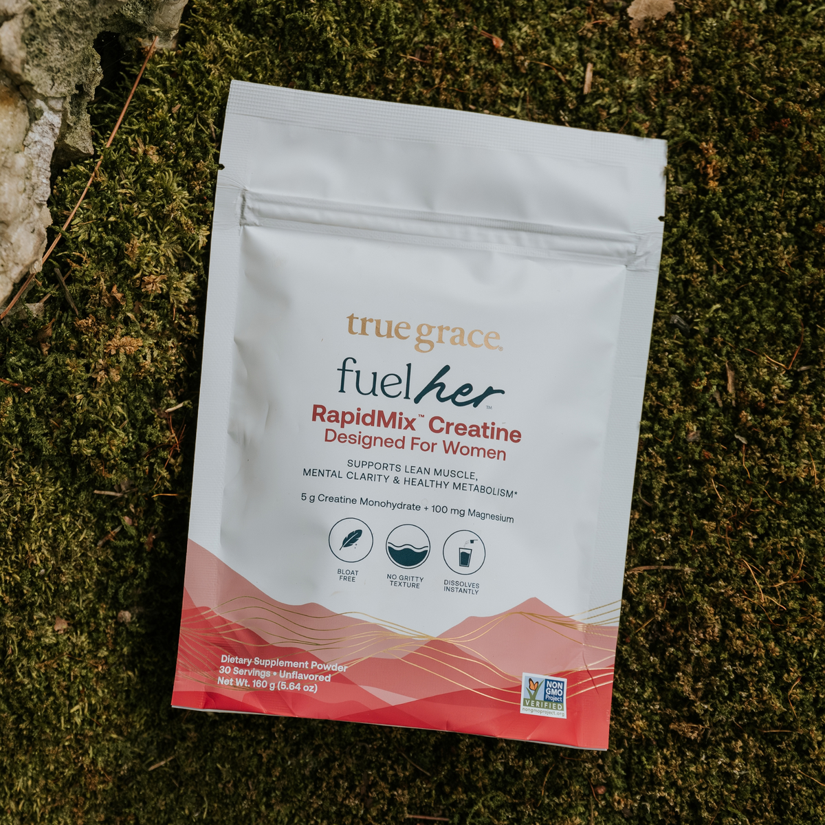 Creatine supplement powder pouch on moss, white with red RapidMix Creatine label