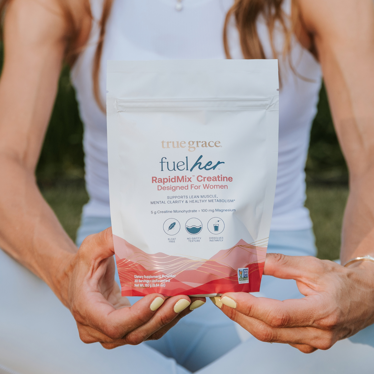 Creatine supplement powder pouch in hands, white with red RapidMix Creatine label