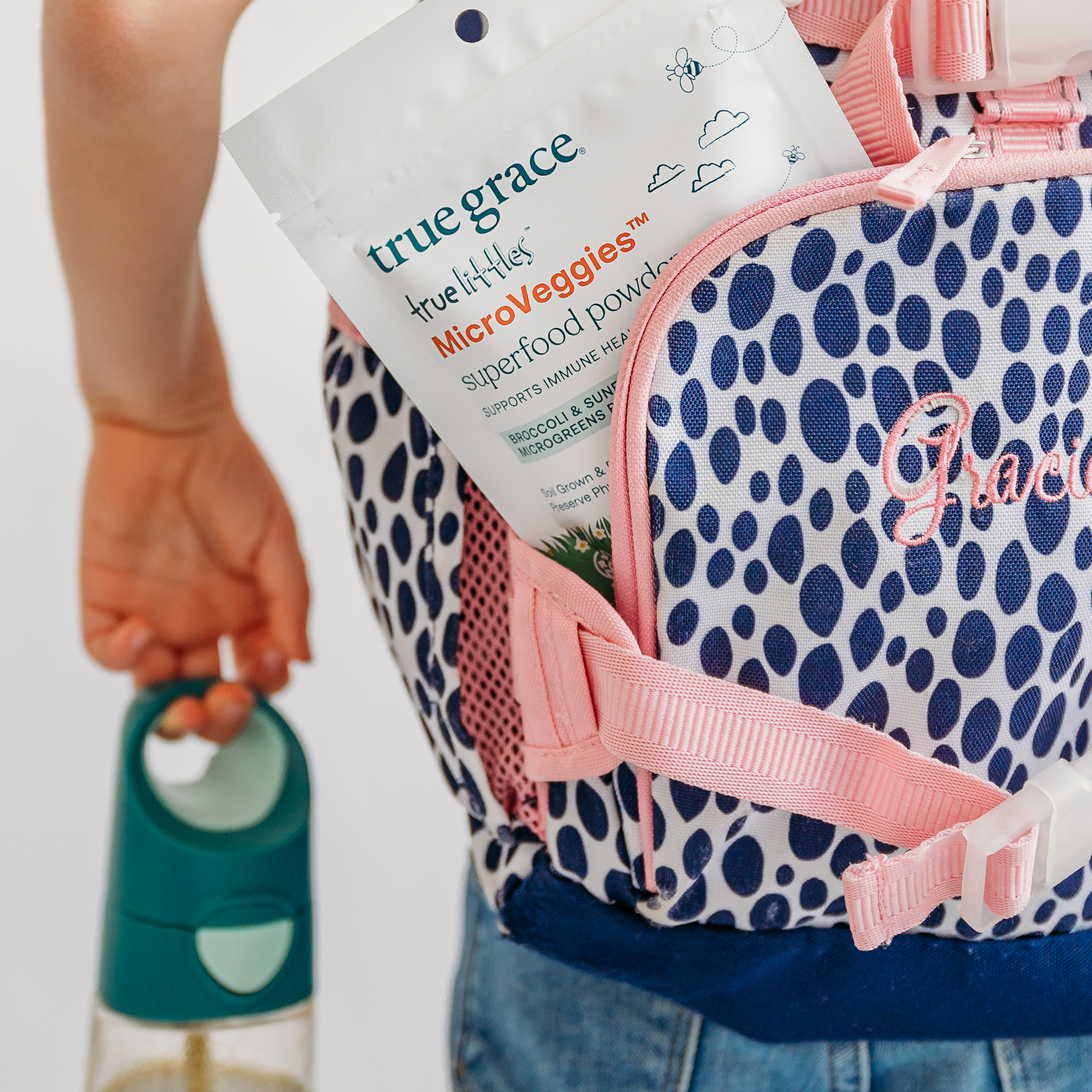 True Grace True Littles MicroVeggies superfood powder package in kids backpack. Our microgreens may be tiny, but the way they’re grown makes a big difference for the health of people and planet.